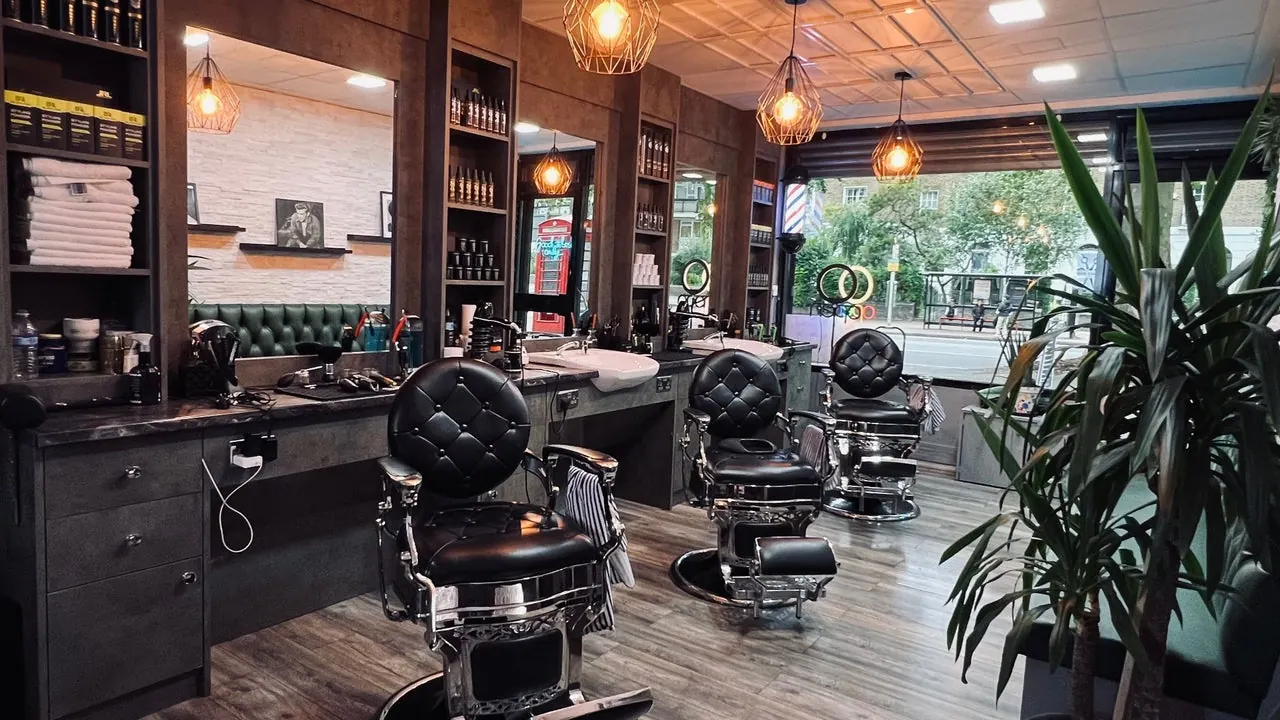Inside London Gents: dark wood, leather chairs and plants